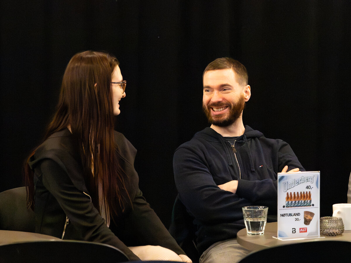Participants in conversation at a table during Usable Fragments 2026